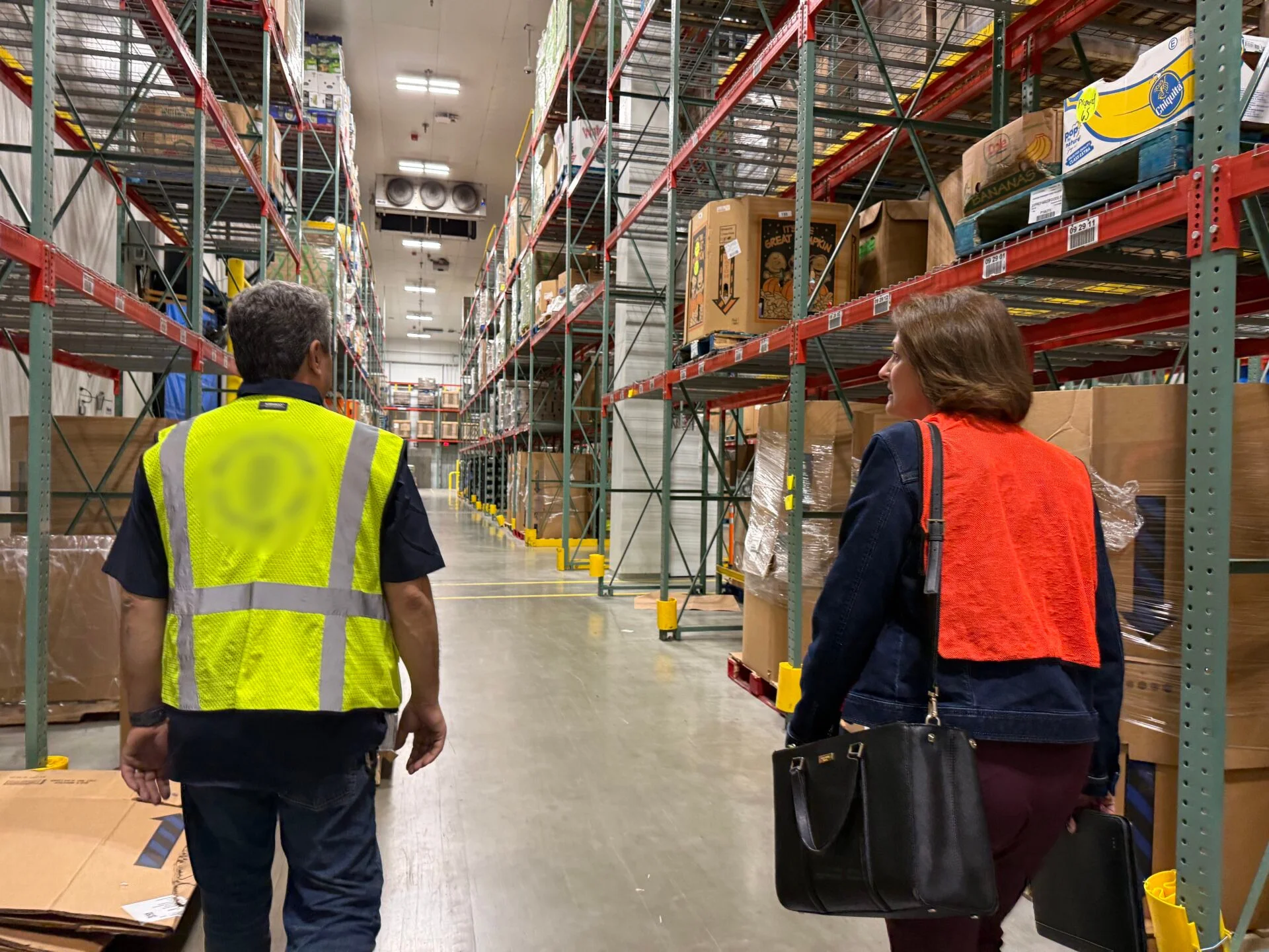 Susan Smith showing the warehouse to a customer